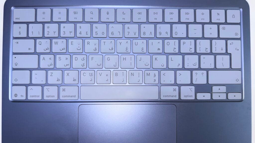 Apple Macbook Neo keyboard and trackpad in indigo color