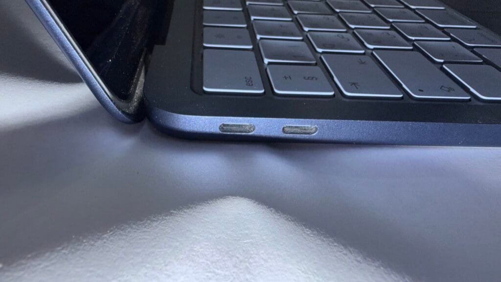 Side view of the MacBook Neo showing dual USB-C ports and slim aluminum chassis