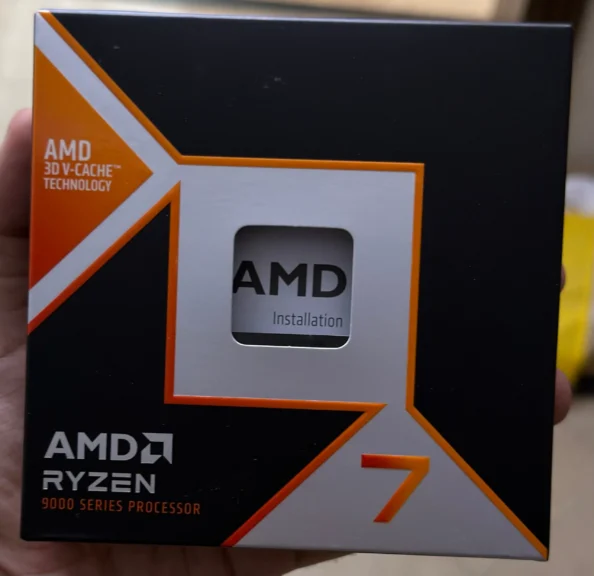 My AMD Ryzen 7 9800X3D retail box showing the Ryzen 9000 Series packaging with AMD 3D V-Cache branding