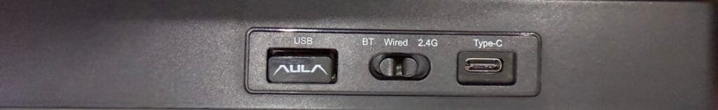 Rear view of my Aula F75 keyboard showing the USB receiver storage, BT/Wired/2.4G mode switch, and USB-C charging port.