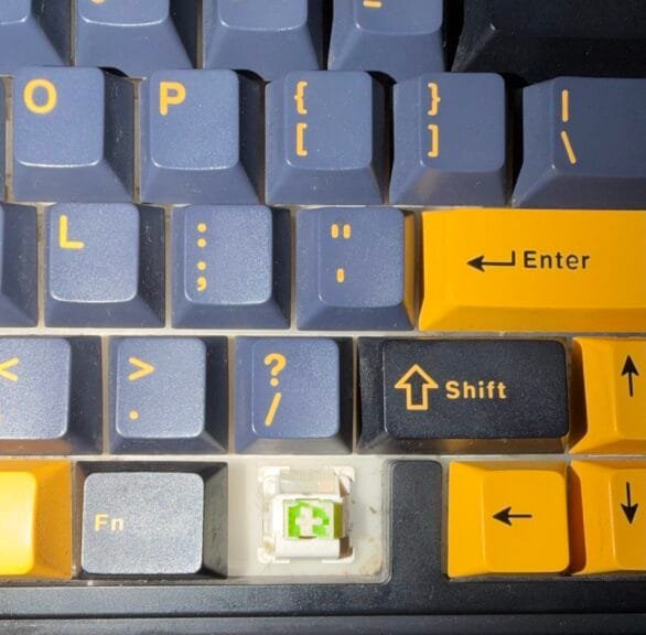 Close-up of my Aula F75 keyboard with a keycap removed, revealing the hot-swappable light green linear switch.